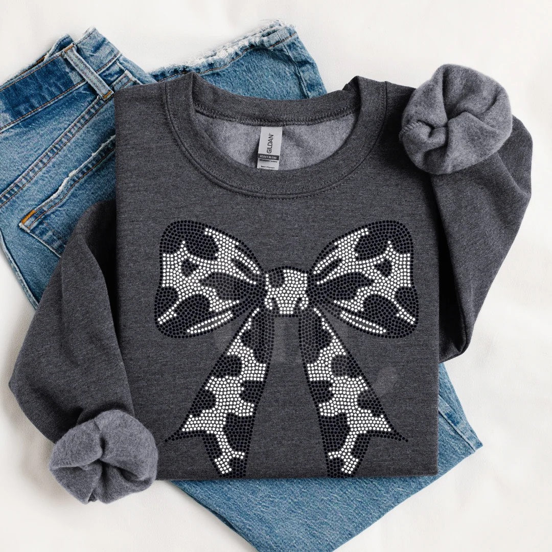 Bow Cow Print-Spangle Crewneck featuring western cow print with spangle bow accent — perfect for cowgirl fashion, rodeo outfits, and country chic style.