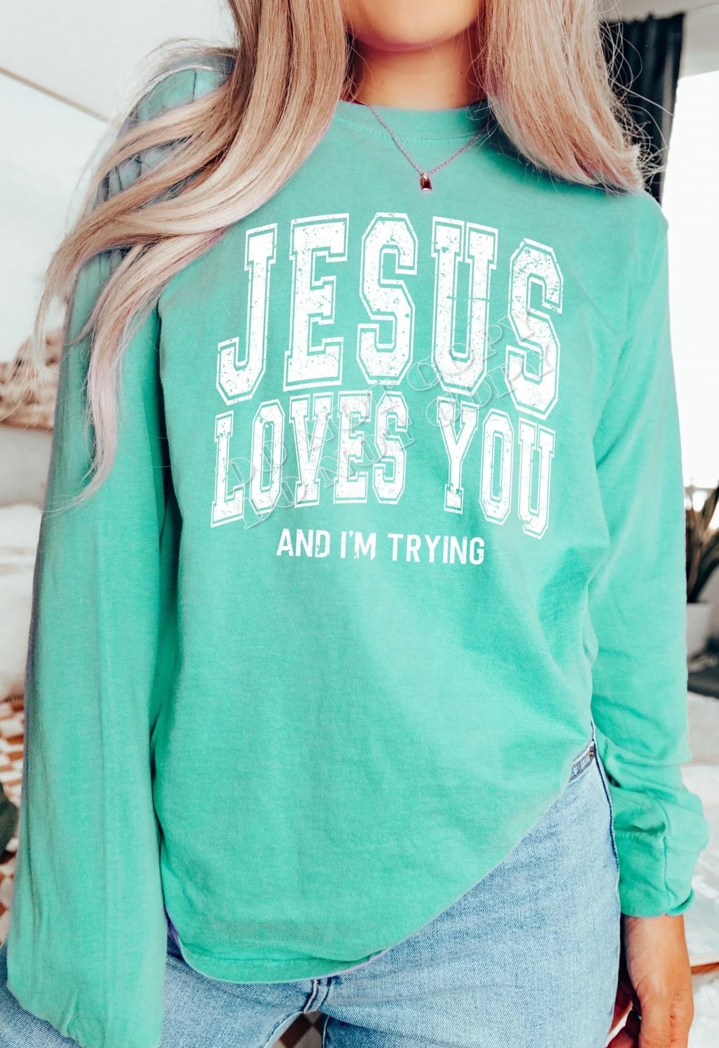 "Jesus Loves You and I'm Trying" Christian sweatshirt – inspirational faith-based apparel with a humorous message, cozy unisex fleece sweater for believers.