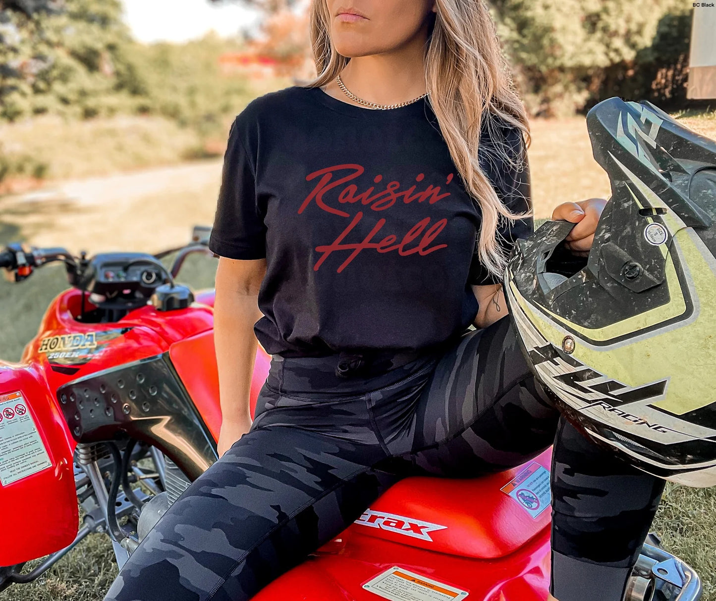 Raising Hell (Red Ink) T-Shirt – edgy unisex graphic tee in bold red lettering, perfect for streetwear, concerts, and festival outfits – LDC Designz.