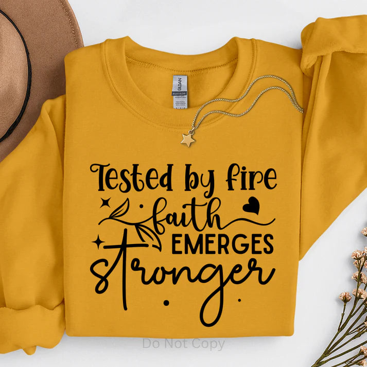 Tested by Fire Faith Emerges Stronger Christian sweatshirt in mustard yellow with inspirational faith quote, cozy religious apparel by LDC Designz.