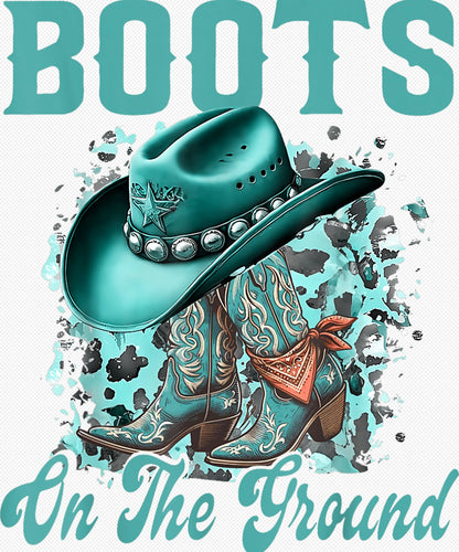 Turquoise “Boots On The Ground” cowgirl shirt design with blue boots, star-studded hat, and distressed splatter background.