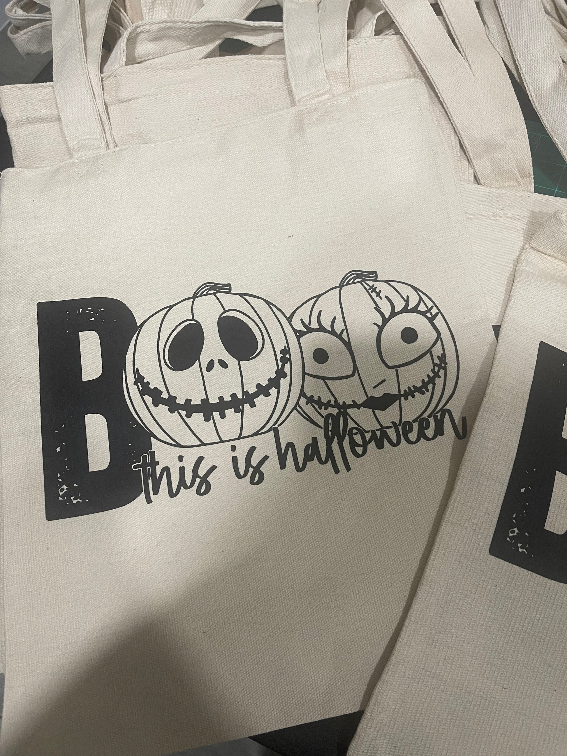 Eco-friendly “Boo This is Halloween” tote bag with spooky text and fall-themed design, perfect for Halloween accessories and trick-or-treating.