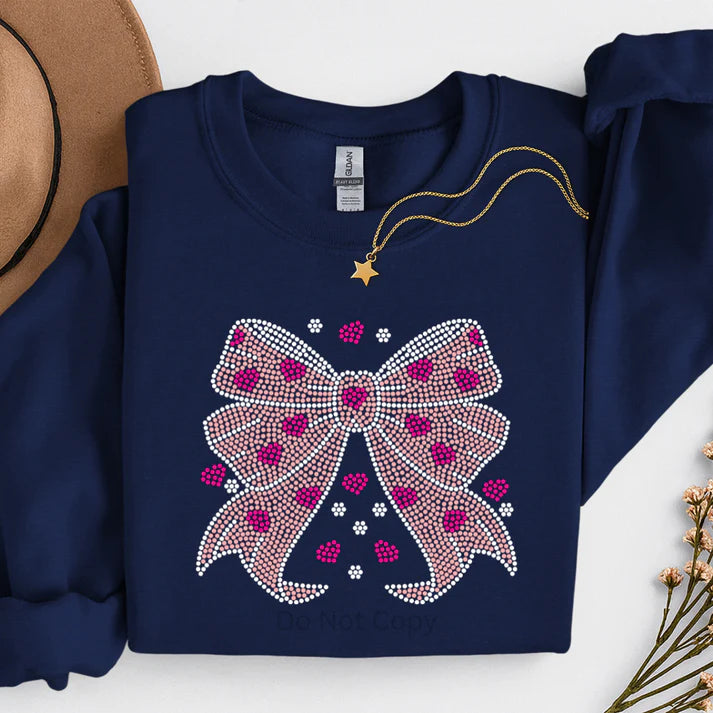 Women’s navy sweatshirt featuring a rhinestone bow and heart design, glam sparkly bow sweatshirt by LDC Designz.