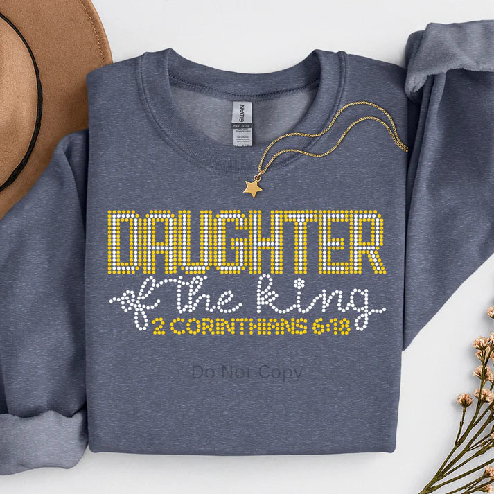 Daughter of the King Christian faith sweatshirt for women featuring rhinestone-style lettering on a cozy crewneck, inspirational religious apparel by LDC Designz.