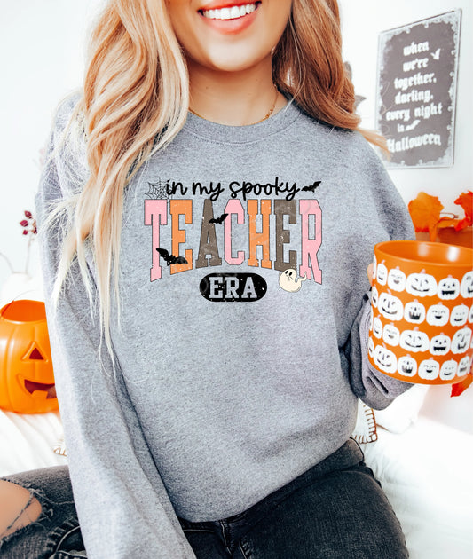 “In My Spooky Teacher Era Sweatshirt — Halloween teacher sweatshirt in bold lettering, cozy cotton-blend fleece perfect for spooky season teacher outfits and Halloween classroom wear.”
