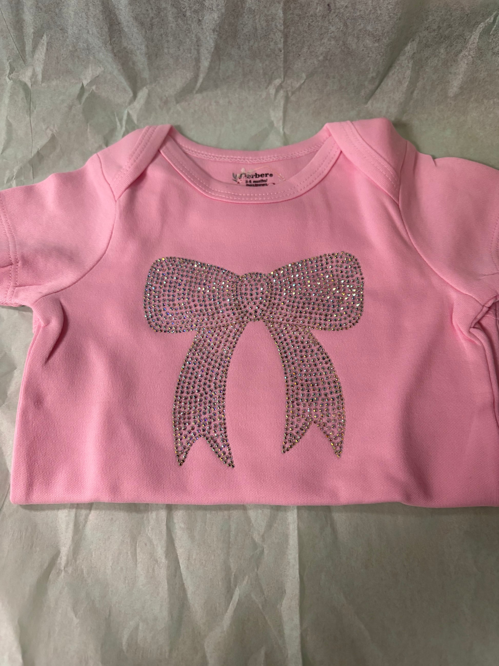 Infant onesie with rhinestone bow design by LDC Designz – soft cotton baby outfit for toddlers and infants featuring sparkling rhinestone accents