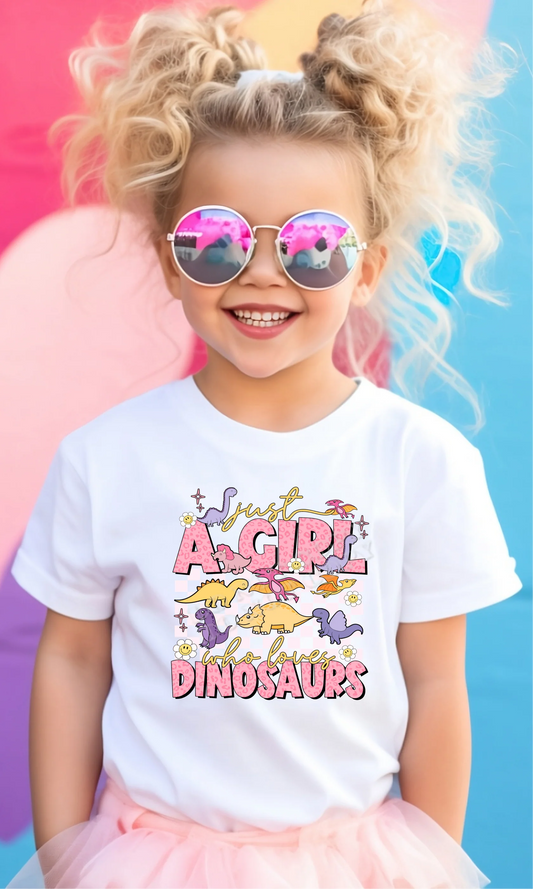 Just a Girl Who Loves Dinosaurs T-Shirt by LDC Designz featuring cute dinosaur print, soft cotton fabric, and fun girls dino graphic tee for all ages.