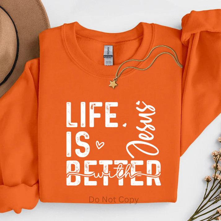 Life Is Better with Jesus sweatshirt in orange featuring inspirational Christian faith typography, faith-based apparel by LDC Designz