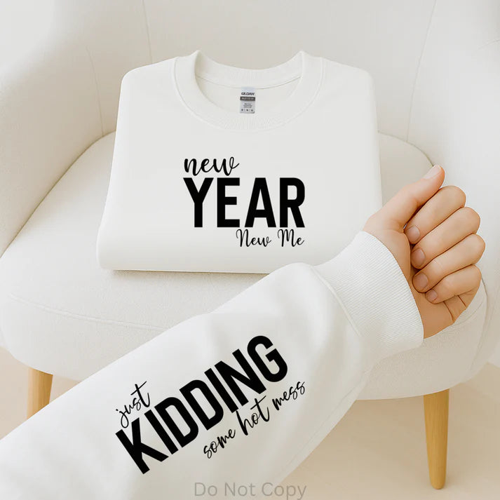 New Year New Me Just Kidding Some Hot Mess graphic sweatshirt with bold black lettering on white sweatshirt, funny New Year statement apparel by LDC Designz