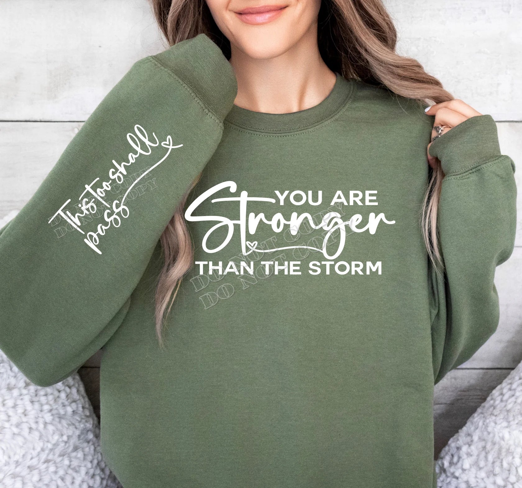 “You Are Stronger Than the Storm Sweatshirt – inspirational graphic crewneck with motivational message, cozy casual wear from LDC Designz.”