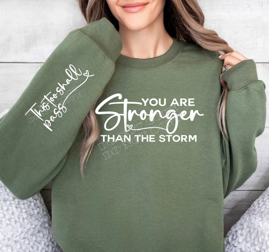 “You Are Stronger Than the Storm Sweatshirt – inspirational graphic crewneck with motivational message, cozy casual wear from LDC Designz.”